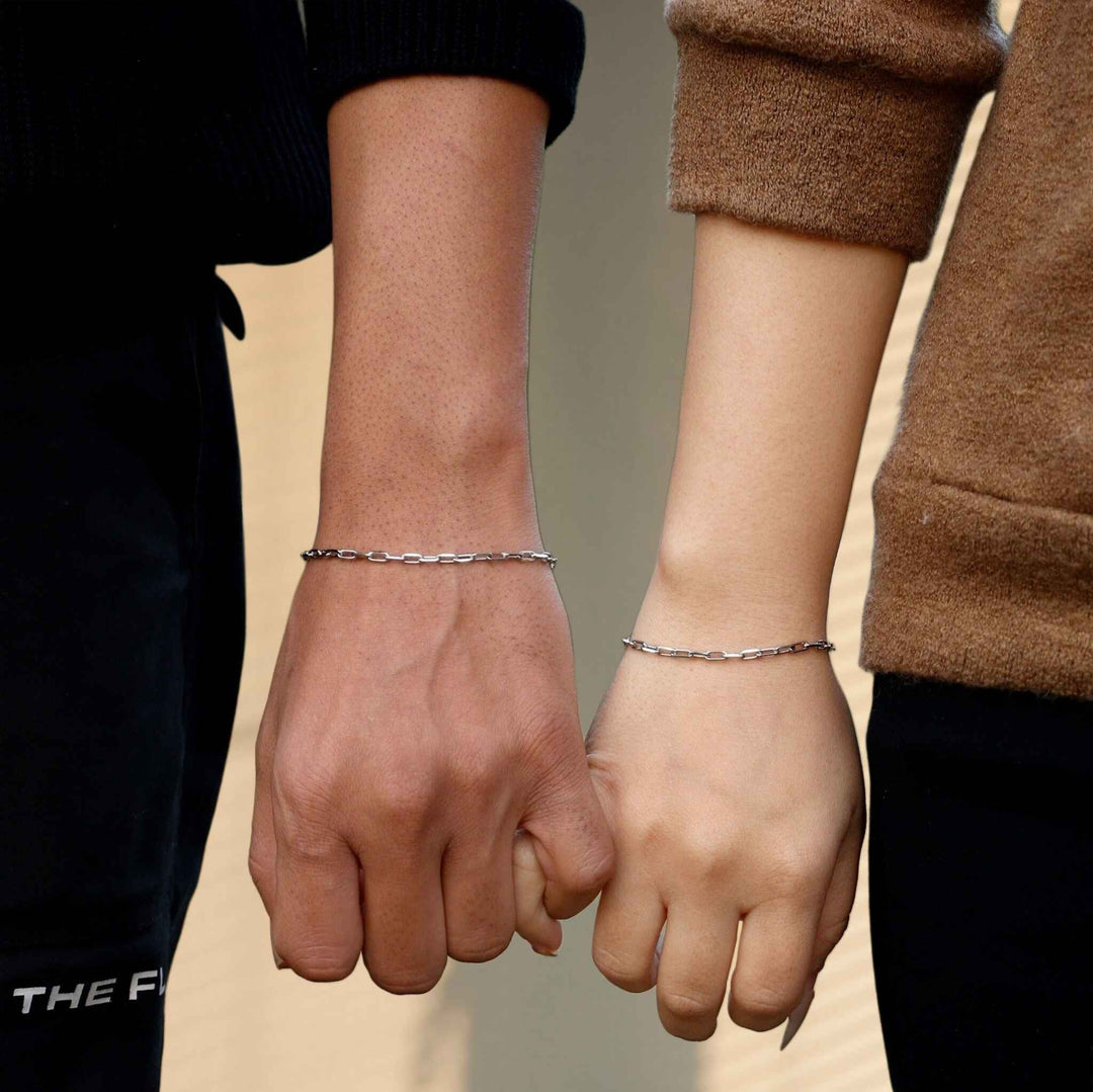 Couple photo wearing silver matching bracelet 
